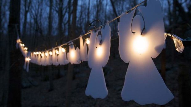 In heaven: Glowing angels hang from trees a month after 20 children and six staff members were killed at Sandy Hook elementary school.