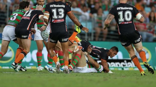 Tim Simona hits Greg Inglis in the tackle that ended the Rabbitohs fullback's game.