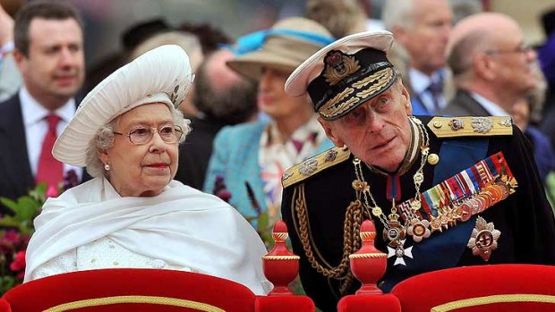 Fallen ill .... Prince Philip, with the Queen, during the Thames Pageant yesterday.
