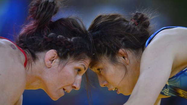 In competition ... Tonya Lynn Verbeek (left) wrestles Saori Yoshida.