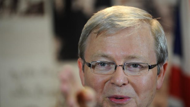 Back in town: Mr Rudd addresses the media at Brisbane airport this morning.