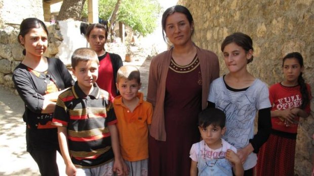 At just 18, Geni Abdullah (centre) is the oldest surviving member of her large, extended family.