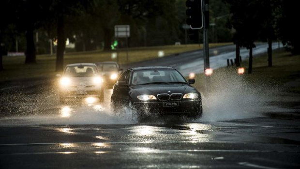 Large puddles of water formed on Canberra Ave following heavy rain on Christmas Eve.