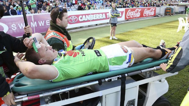 Season over: Raiders winger Jack Wighton was stretchered off with a suspected broken ankle.