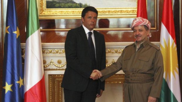 Iraqi Kurdish regional President Masoud Barzani shakes hands with Italy's Prime Minister Matteo Renzi in Erbil.