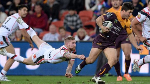 Out of reach: Warriors fullback Sam Tomkins tries to reel in Broncos halfback Ben Hunt.