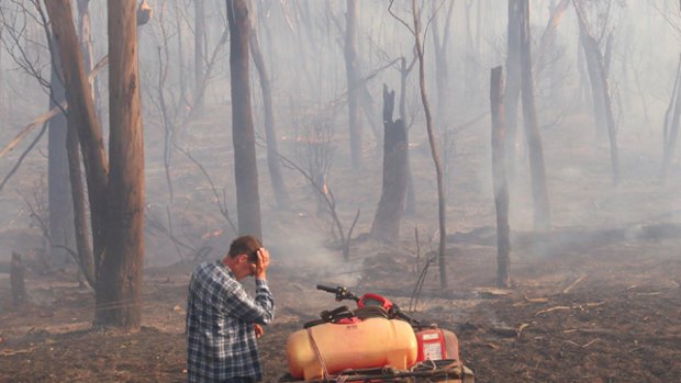 A farmer sees the effect of fire on his land at Labertouche.