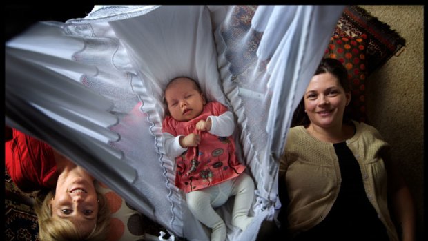 Sian Baird, right, with her third child, five-week-old Seraphine, and midwife Bronwyn Madigan, was discharged from Sunshine Hospital just four hours after giving birth.