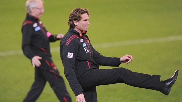 Kicking on, or not? Essendon coach James Hird kicks a ball on the ground before Saturday night's match against Carlton.