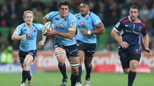On the run: Dave Dennis makes a break during the Waratahs' below-par performance against the Rebels on Friday night.