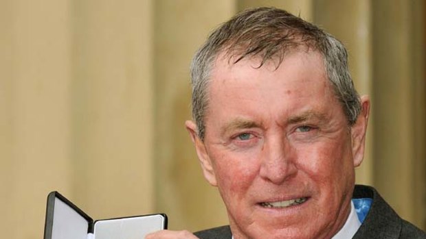 Actor John Nettles holds the insignia of Officer of the British Empire (OBE) medal.