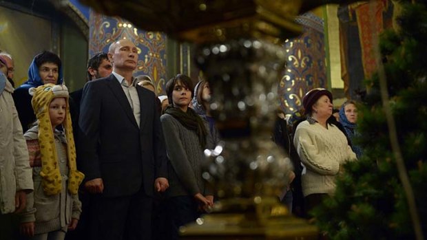 Russian President Vladimir Putin attends the Orthodox Christmas service at the Holy Face of Christ the Saviour Church in Sochi on Tuesday.