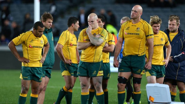 Tough road ahead ... Wallabies players stand dejected after losing to New Zealand in Auckland last month.