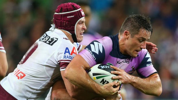 On the defence: Matt Ballin tackles Cooper Cronk at AAMI Park on Monday night.