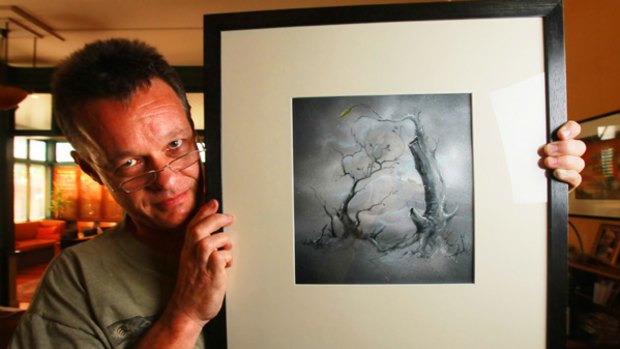 Children's author Graeme Base with the artwork featured in last week's Sunday Age that   he has donated to be  auctioned on eBay to raise money for fire victims.