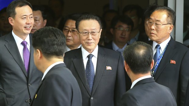 Kim Yang-gon (centre) arriving for talks in South Korea in October 2014.