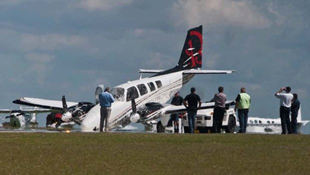 Two people on board this plane escaped without injury when its nose gear failed while landing at the Toowoomba Airport.