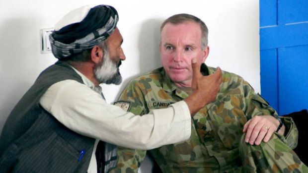 Model major-general &#8230; John Cantwell sits down with a village chief in Afghanistan.