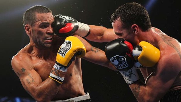 Scoring points ... IBF middleweight world title winner Daniel Geale lands a right on Anthony Mundine on Wednesday night  at the Sydney Entertainment Centre.