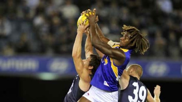 West Coast's Nick Naitanui came out on top in this marking contest against Richard Hadley and Sam Jacobs.