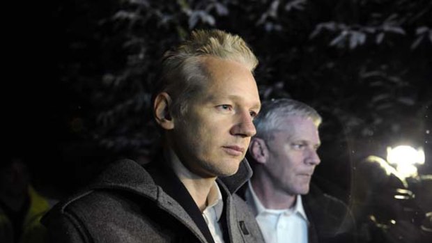 WikiLeaks founder Julian Assange speaks to the media outside Ellingham Hall as WikiLeaks spokesman Kristinn Hrafnsson looks on.