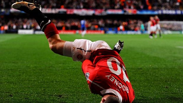 Dizzy heights ... Wayne Rooney spins on his head after scoring.