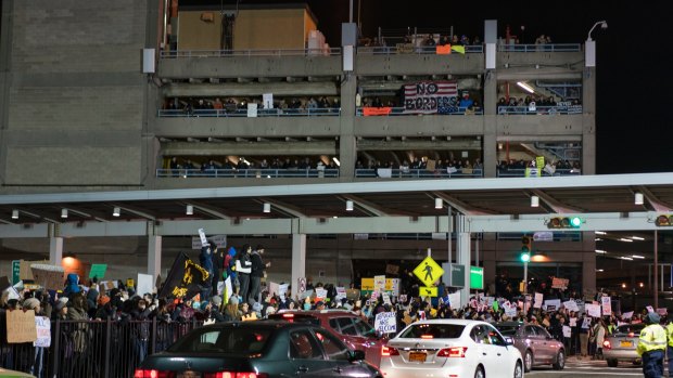 Crowds have protested the bans at John F Kennedy International Airport in New York.