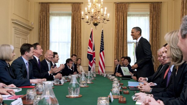 US President Barack Obama, standing right, addresses an expanded bilateral meeting at 10 Downing Street in London.