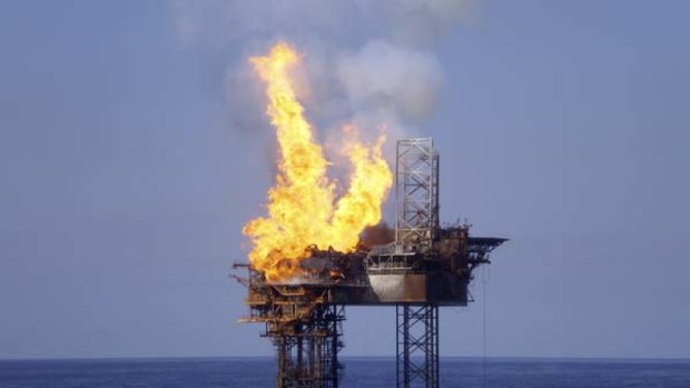 Fire burns on the partially collapsed West Atlas rig in the Timor Sea off Western Australia's Kimberley coast in August. The Montara oil spill inquiry is due to report next week.