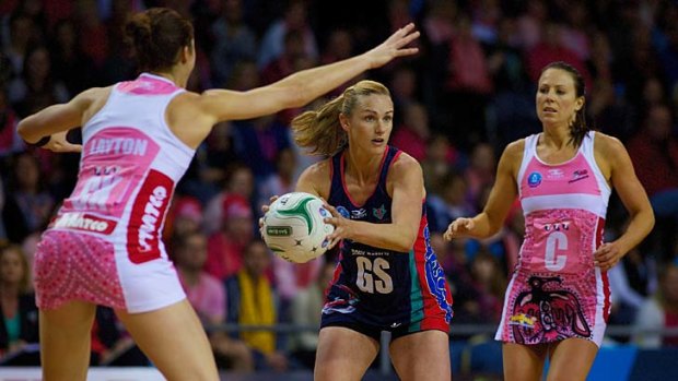 Sharelle McMahon with the ball, flanked by Sharni Layton (left) and Natalie Von Bertouch.