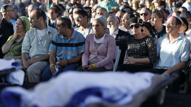 Parents of the three Israeli teenagers killed in the West Bank mourn during the funeral of their sons.