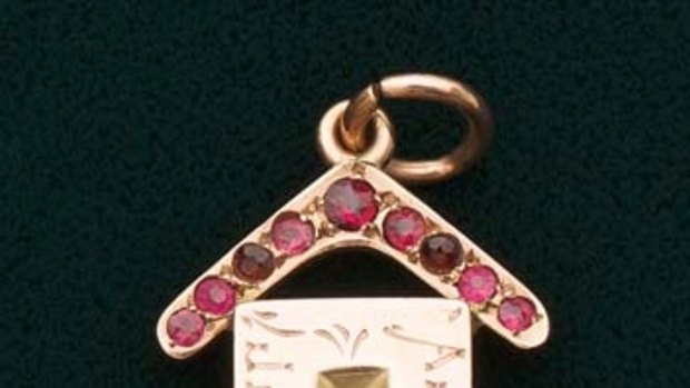 A keepsake from the first Australia Day. A nine carat gold pendant in the form of a brick, a ruby set boomerang above, engraved "Australia Day, July 30th 1915".