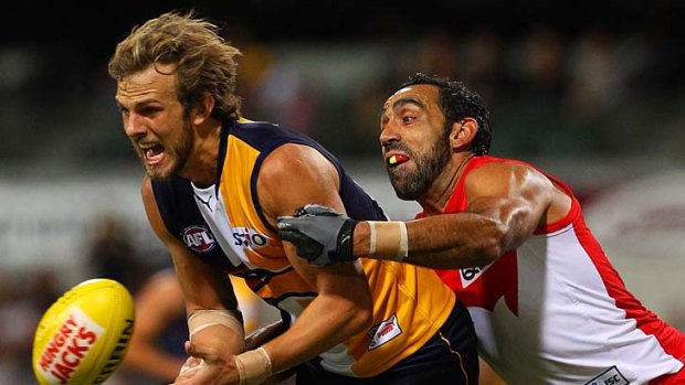 Solid defence: Sydney's Adam Goodes tackles the Eagles' Will Schofield.