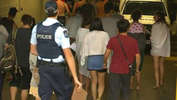 Police evacuate schoolies from a building at Surfers Paradise.