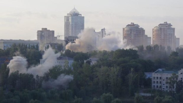 Smoke billows over apartment blocks following shelling in Donetsk.