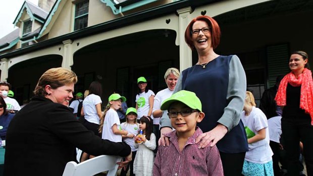 Smile, please: Julia Gillard greets families at a tea party at Kirribilli House to promote her Gonski education reforms.
