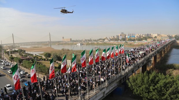Striking back: pro-government demonstrators rally in the restive south-western Iranian city of Ahvaz on Wednesday.