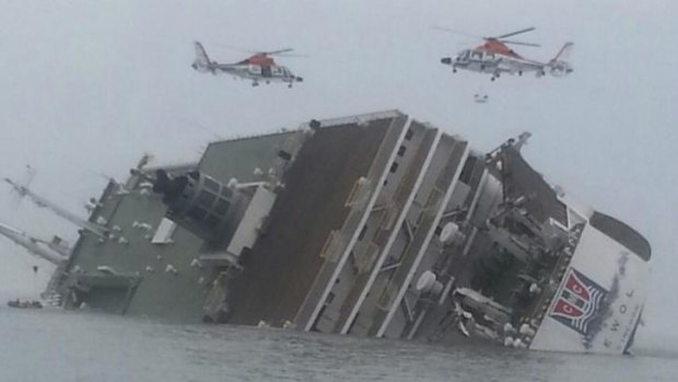 Rescue helicopters hover above the stricken Sewol after it capsized.