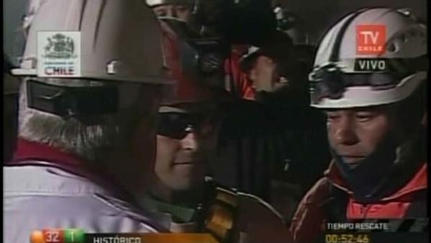 A TV grab taken from the Chilean TV channel TV Chile, shows Chilean miner Florencio Avalos, centre, just after coming out of the rescue capsule.
