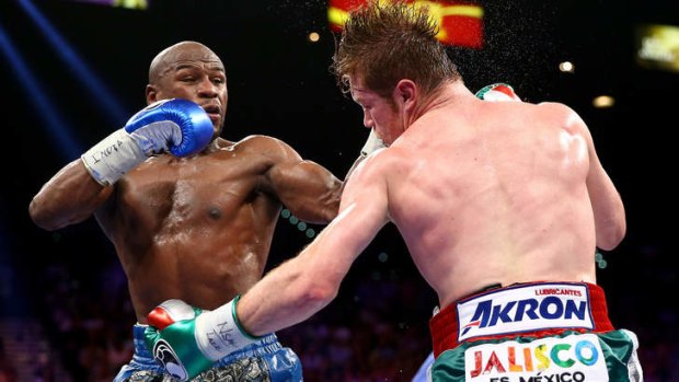 Floyd Mayweather Jr. throws a left at Canelo Alvarez during their WBC/WBA 154-pound title fight at the MGM Grand Garden Arena.