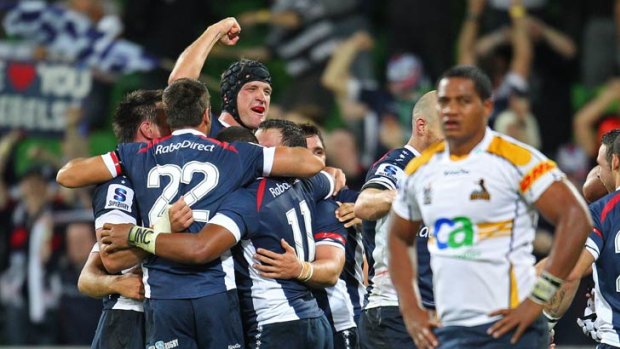Melbourne Rebels players celebrate the new club's victory over the Brumbies.