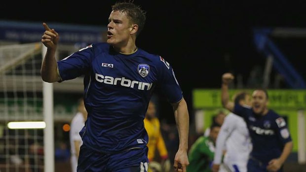 Bring on the replay  ...  Oldham Athletic's Matt Smith celebrates scoring the equaliser.