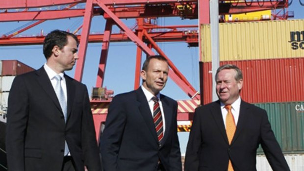 All aboard ... Tony Abbott tours a Fremantle port with Colin Barnett and Michael Keenan. He promised border security funds.