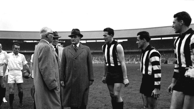 Collingwood players Murray Weideman and Thorold Merret meet Sir William Slim at the 1958 VFL grand final.