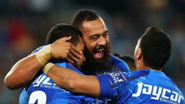 Dogs back on top: Canterbury players Sam Kasiano, Krisnan Inu and Drury Low celebrate during the upset win over Manly.