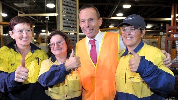 Thumbs up ... Tony Abbott with workers at the Ford factory in Geelong.