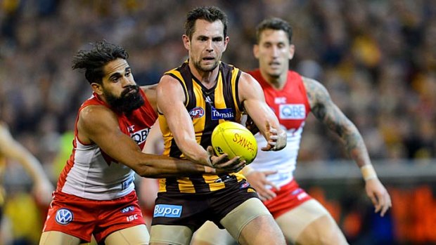 Hawthorn's Luke Hodge is tackled by Lewis Jetta.
