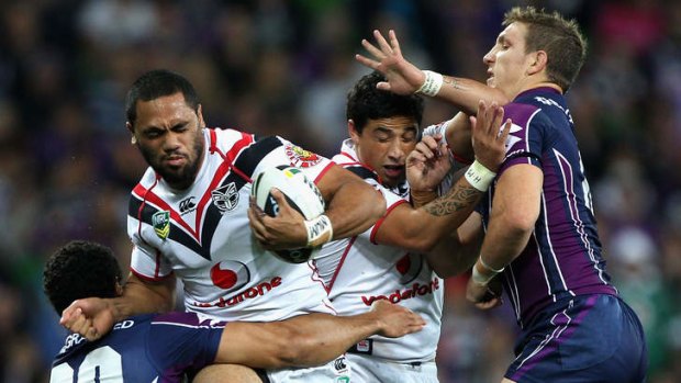 Gotcha: Warrior Bill Tupou is tackled by Storm opponents at AAMI Park on Thursday night.