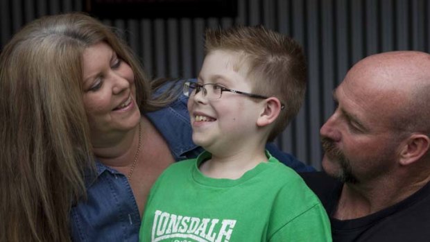 Wait is over ... Charlie Munns, now 10, with his parents, Julie-Anne and Grant. ''It seemed like all hope to give Charlie a chance was slipping away,'' Mrs Munns said.