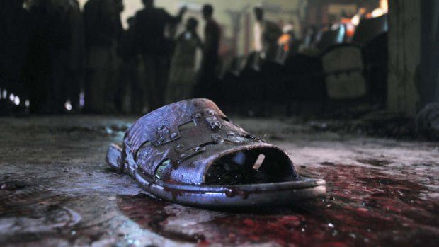 Ruthless ... A blood-stained shoe of a victim lies on the ground at the site of a grenade attack on a crowded cinema that killed 13 and wounded many others in Peshawar, Pakistan.